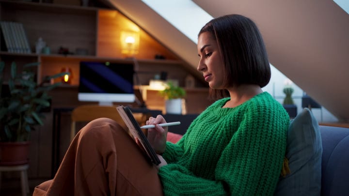 Woman Immersed In Digital Creativity At Cozy Home