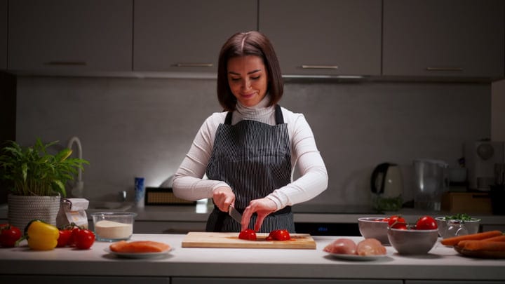 A Woman Prepares Fresh Ingredients In Her Kitchen
