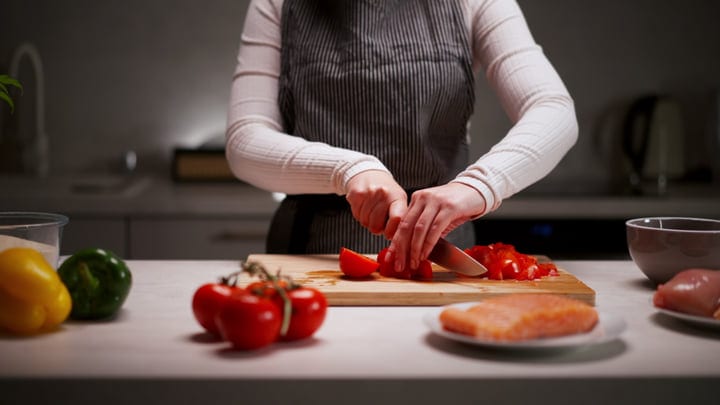 Hands Skillfully Prepare A Vibrant Evening Meal