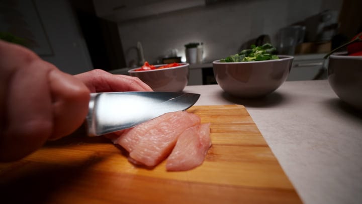 Chopping Fresh Ingredients In A Cozy Kitchen Setting