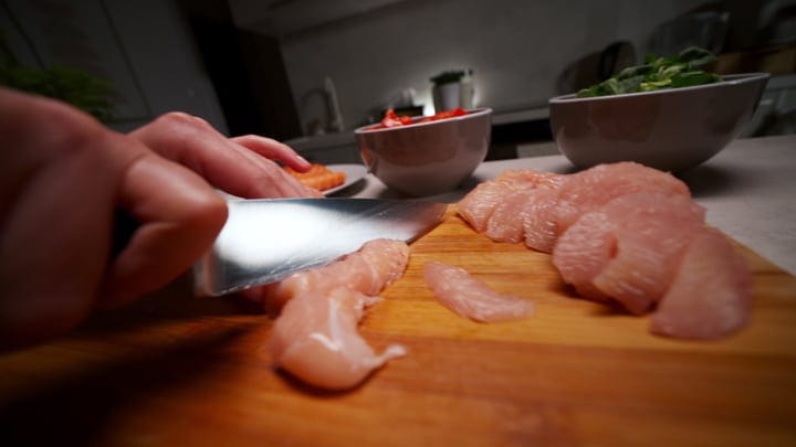 Slicing Fresh Ingredients For A Cozy Home Meal Preparation