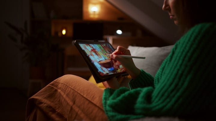 Creative Evening: Woman Painting on Digital Tablet at Home