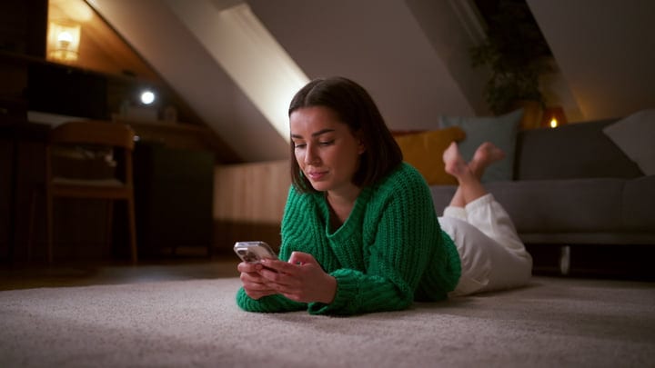 Woman Enjoys Cozy Evening Browsing Her Phone