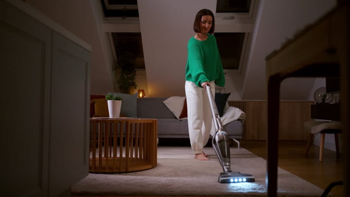 Evening Routine: Woman Vacuuming Her Cozy Living Room