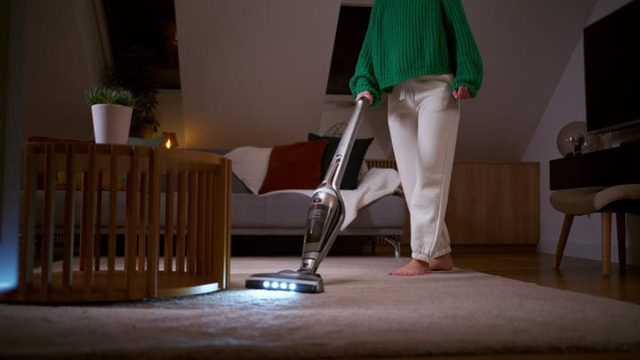Cozy Evening Cleaning In A Warmly Lit Living Room
