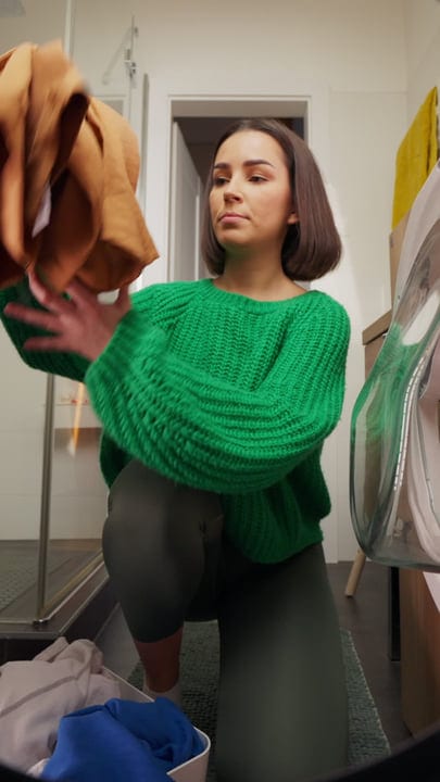 A Woman Organizes Her Wardrobe In Cozy Home