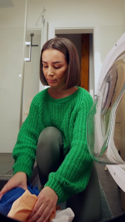 Everyday Chores: Woman Prepares Laundry in Cozy Home
