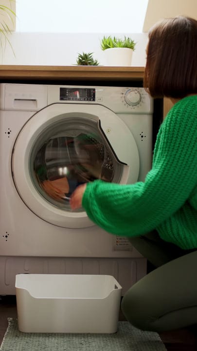 Embrace the Routine: A Woman Loading the Washing Machine