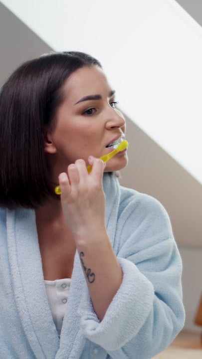 Morning Rituals: Woman Brushing Her Teeth at Home
