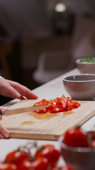 A Home Chef Slices Tomatoes For A Fresh Meal
