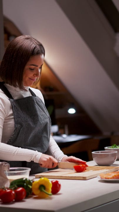 A Woman Finds Joy Chopping Vegetables At Home