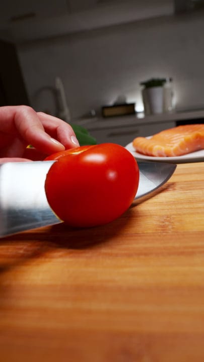 Slicing Fresh Tomatoes In A Cozy European Kitchen
