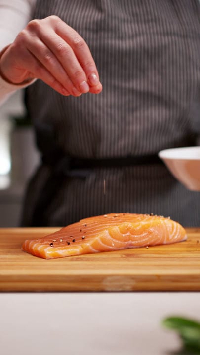 A Culinary Moment: Seasoning Salmon in a Cozy Kitchen