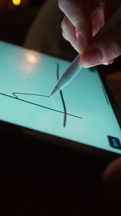 A Woman's Hand Drawing Art on a Tablet