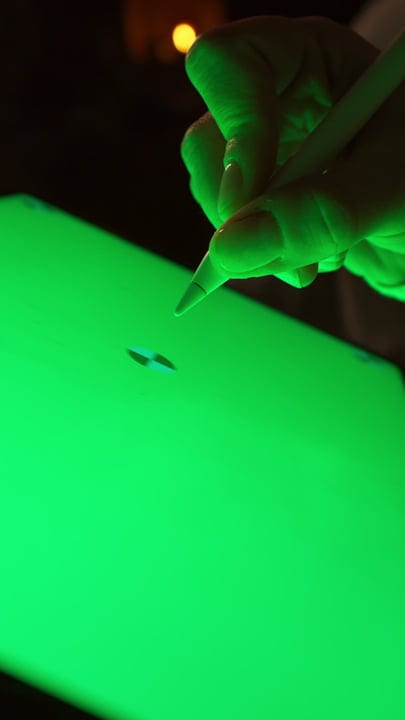 Intricate Crafting Under Neon Green Glow