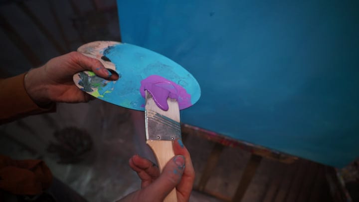 Mixing Vivid Colors In A Creative Artist's Studio