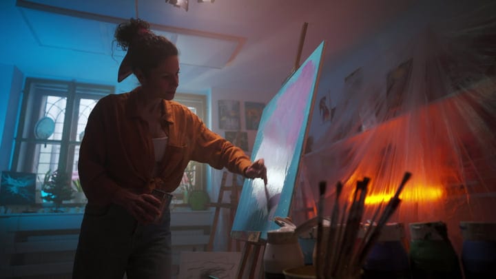 An Artist Immersed In Her Craft Under Soft Studio Light