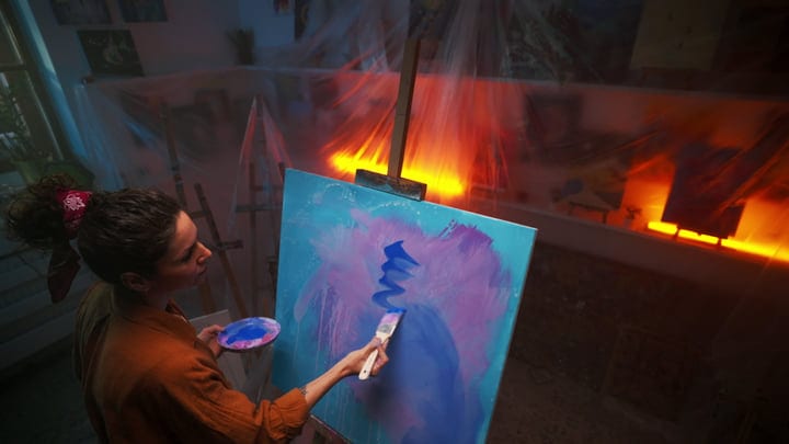 Artist Immersed In Creation Under Warm Studio Lights