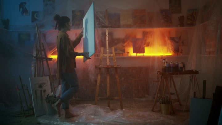 Artist Immersed In Creative Work In Ambient Studio Lighting