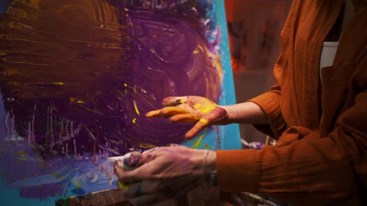 Artist's Hands Dance With Color On Canvas