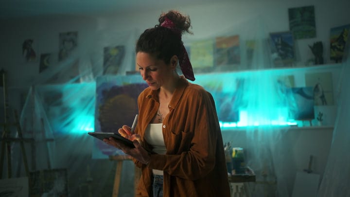 Focused Artist Creating Digital Masterpiece In Studio Light