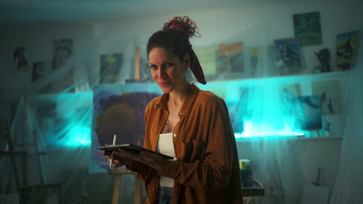 Contemplative Artist Engages With Digital Canvas In Studio