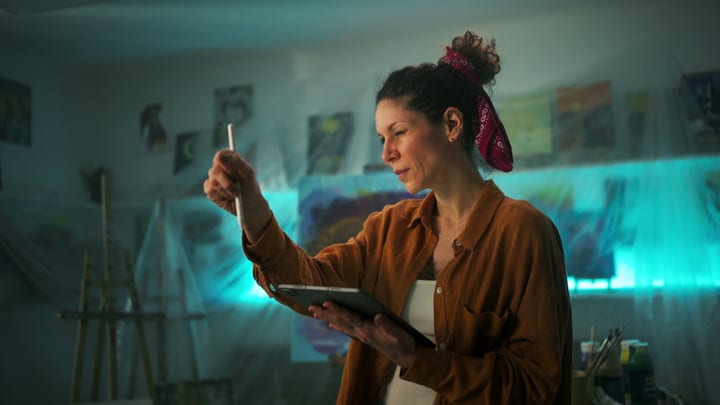 Captivated Artist Entranced By Her Canvas In Studio Glow