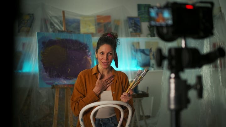 Artist Reflects In Her Studio Amidst Creative Chaos
