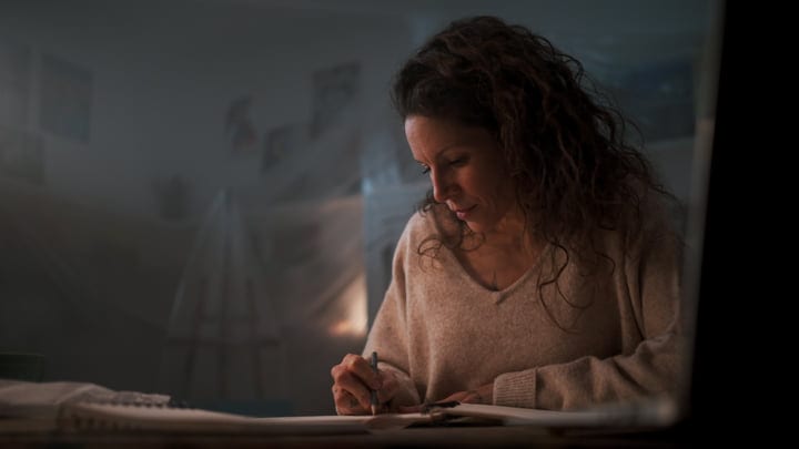Focused Artist Sketching Ideas In A Cozy Studio Ambiance