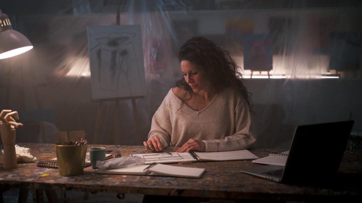 Creative Process Unfolds In Dimly Lit Artist Studio