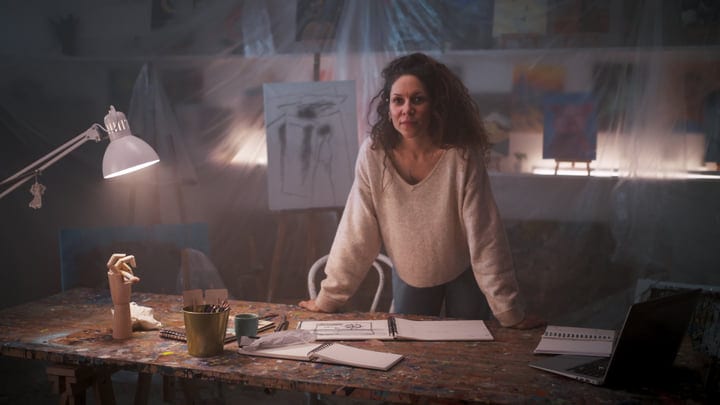 Contemplative Artist Immersed In Creative Studio Atmosphere