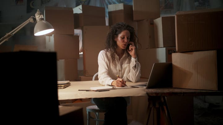 Creative Work Calls Amidst Cardboard Chaos
