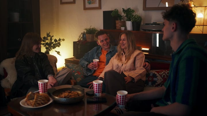 Friends Laugh Together in a Warm Living Room Setting