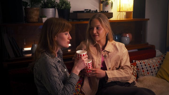 Evening Conversations Over Warm Drinks In Cozy Living Room