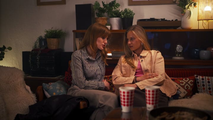 Two Friends Share Secrets On A Cozy Evening