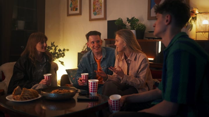 Warm Laughter Fills A Cozy Living Room Gathering