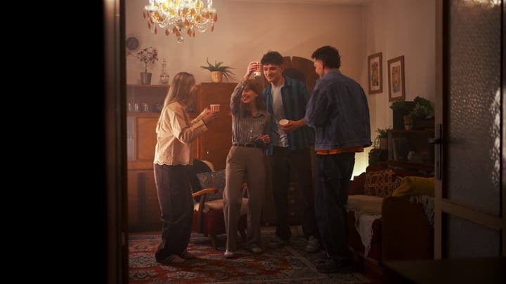 Joyful Toasts Amid Warm Lights In A Cozy Living Room