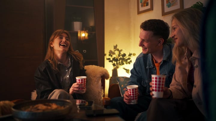 Laughter Echoes Among Friends In A Cozy Living Room
