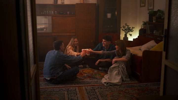 Warm Laughter And Clinking Mugs In Cozy Living Room