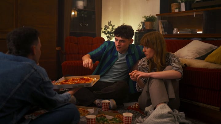 Lively Friends Share Pizza On A Cozy Evening