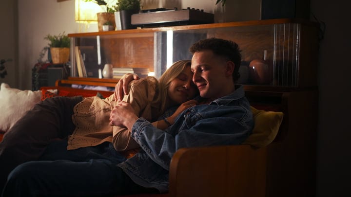Evening Embrace on a Cozy Couch by Candlelight