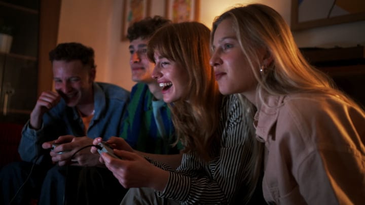 Friends Immersed In A Lively Video Game Night