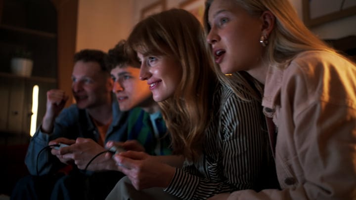 Friends Immersed In A Thrilling Game Night Experience