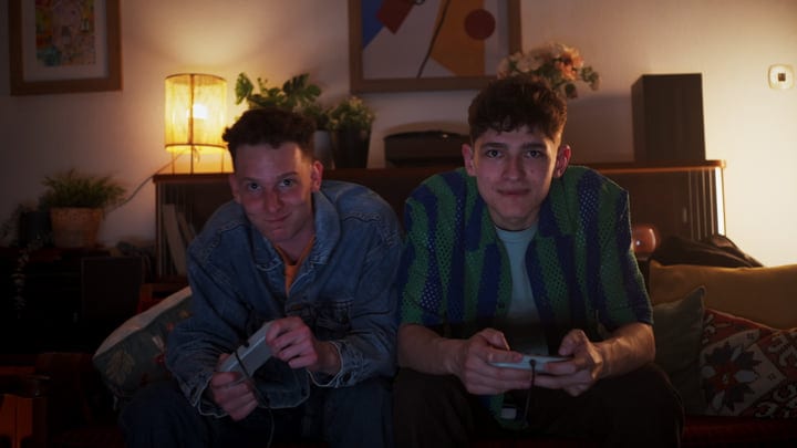 Two Friends Immersed In An Evening Video Game Session