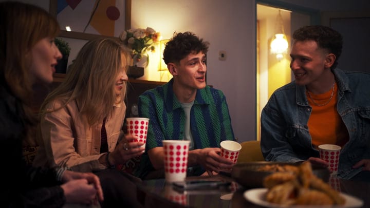 Laughter and Warm Drinks Brighten a Cozy Evening
