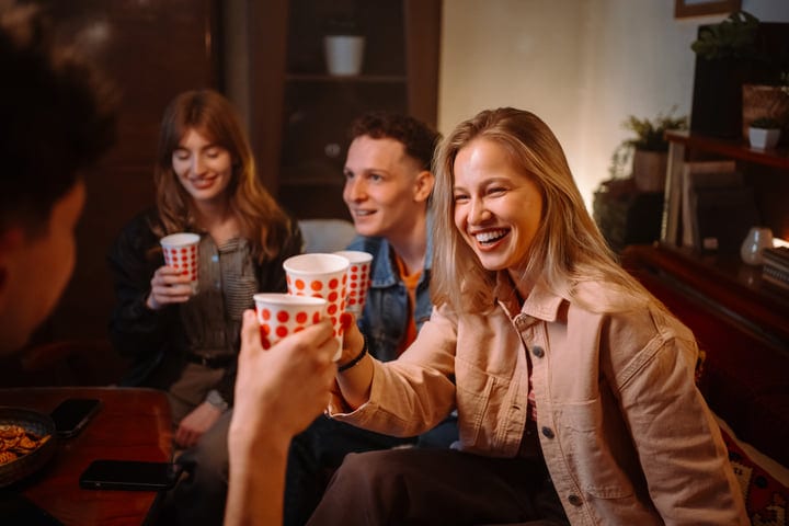 Laughter Echoes as Friends Share Warm Moments Indoors