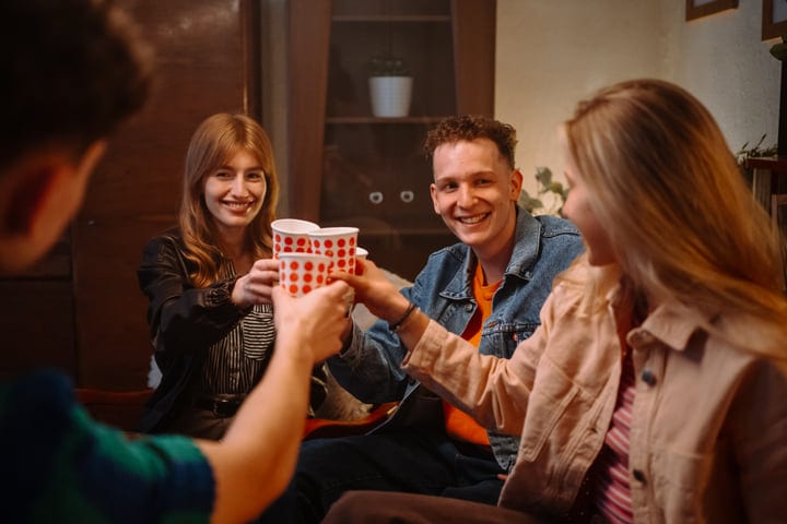 Laughter And Cheer Fill A Cozy Evening Gathering