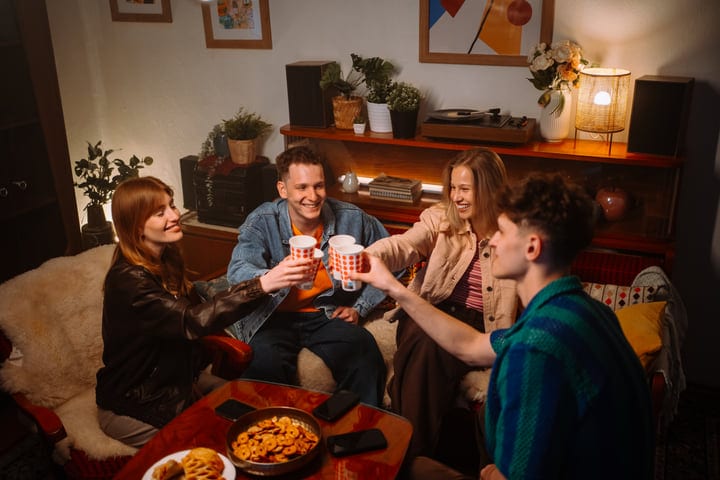 Friends Share Laughter and Toast in Cozy Living Room