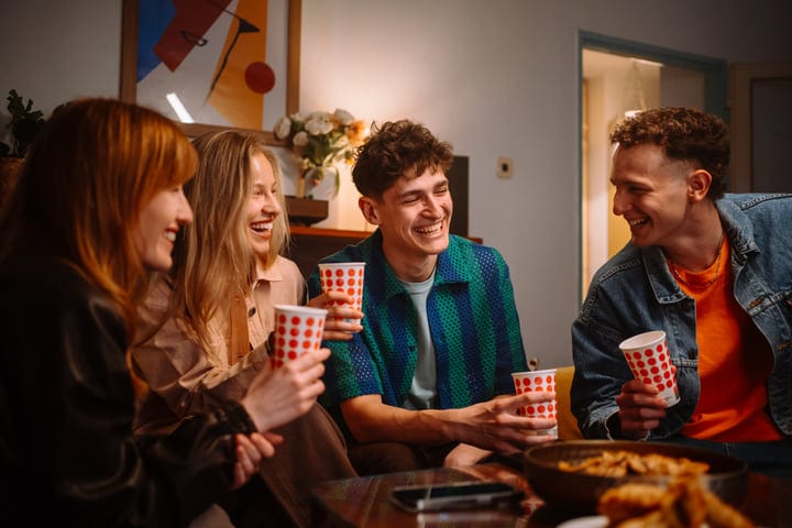 Laughter Fills The Room As Friends Share Drinks