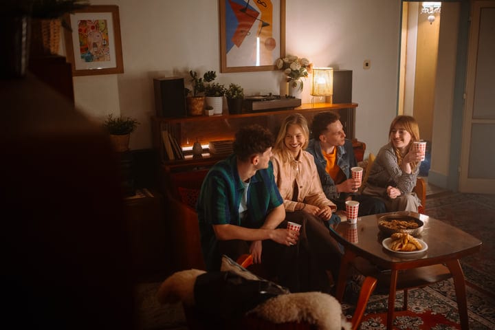 Laughter Fills The Room At A Cozy Evening Gathering